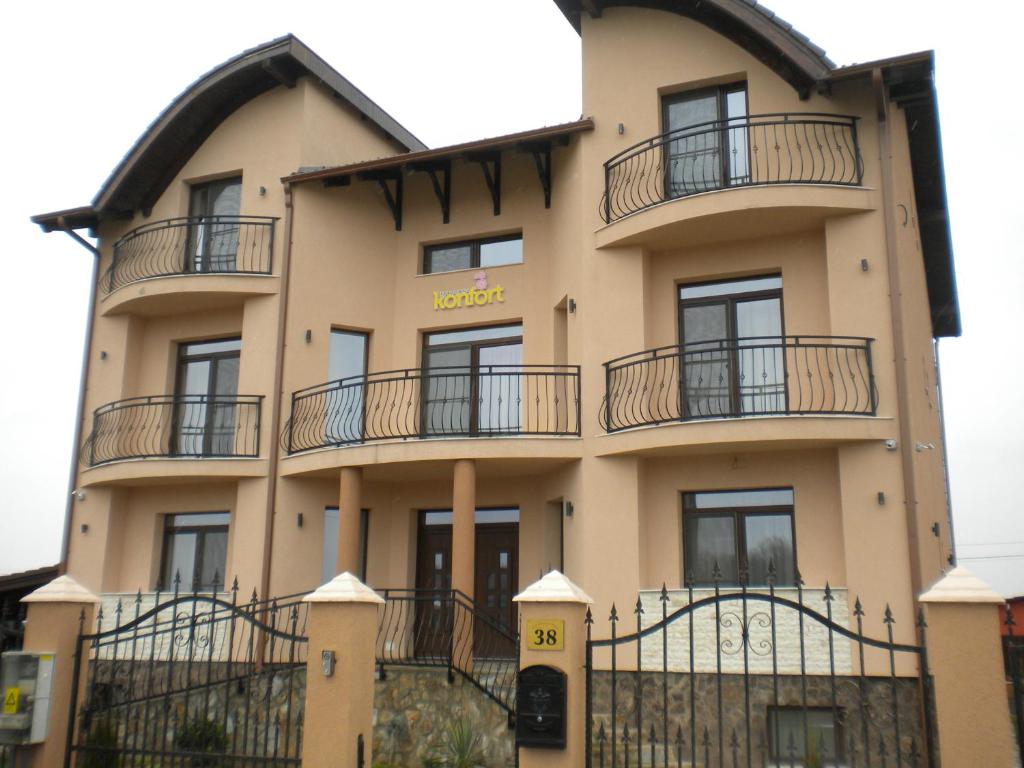 a building with balconies on the side of it at Pensiunea Konfort in Baile Felix