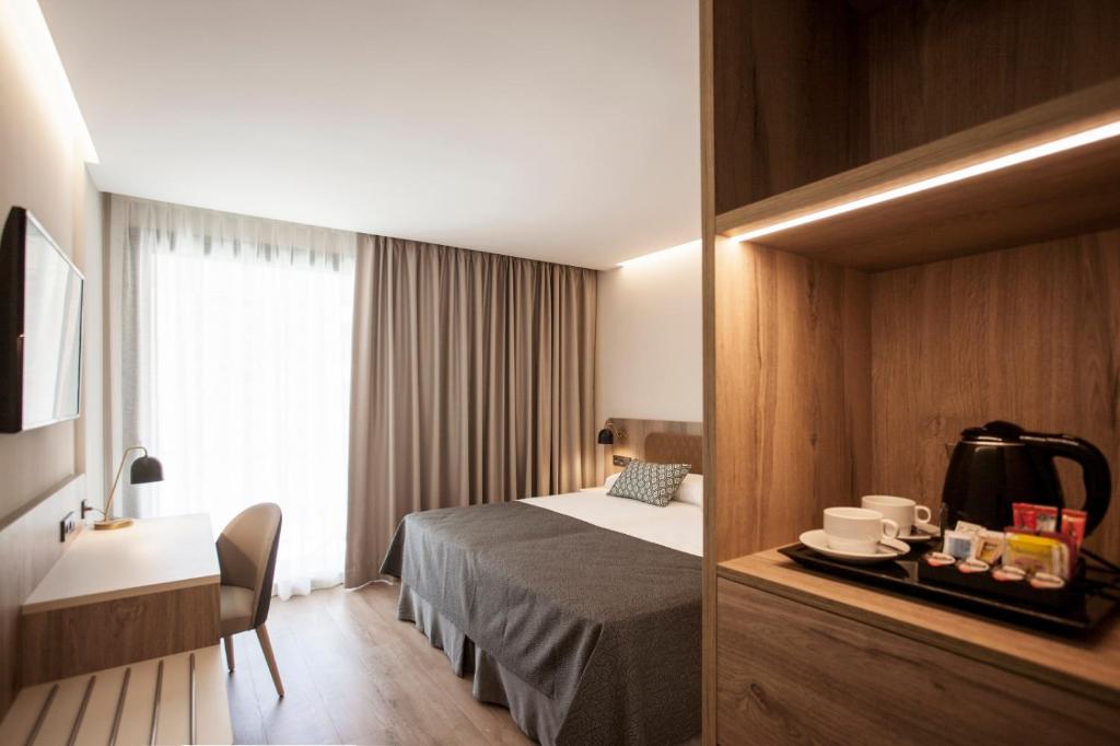 Łóżko lub łóżka w pokoju w obiekcie Hotel Presidente 4 sup