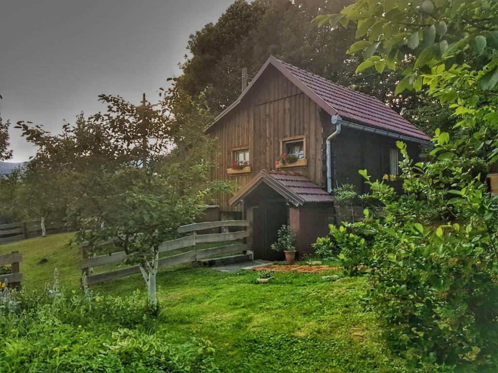 a wooden house with a window on the side of it at Apartments Novela in Poljanak