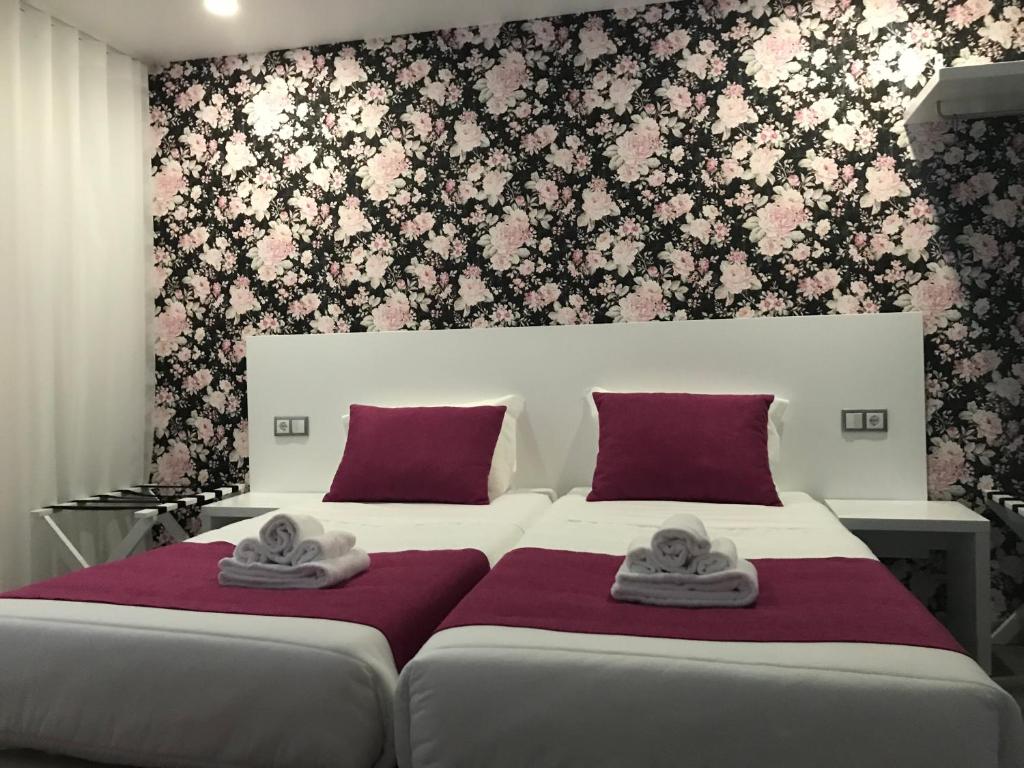 a bedroom with two beds with towels on them at PinoyHouse Fatima in Fátima