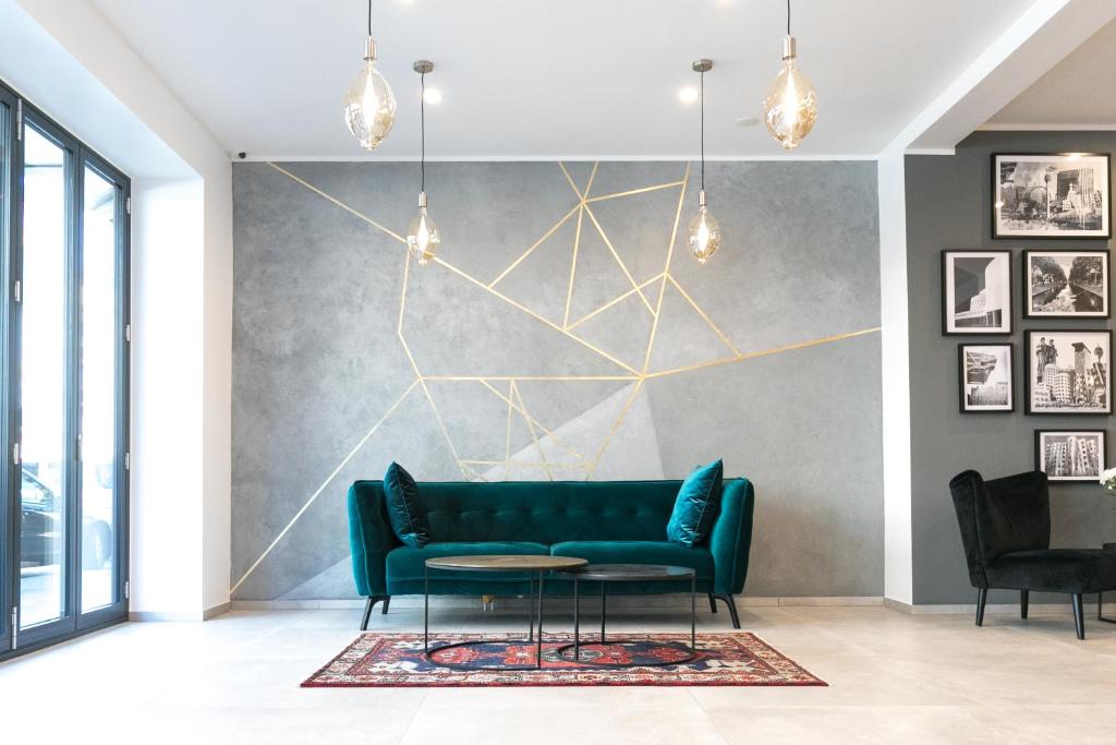 a living room with a couch and a table at Sleep Inn Düsseldorf in Düsseldorf