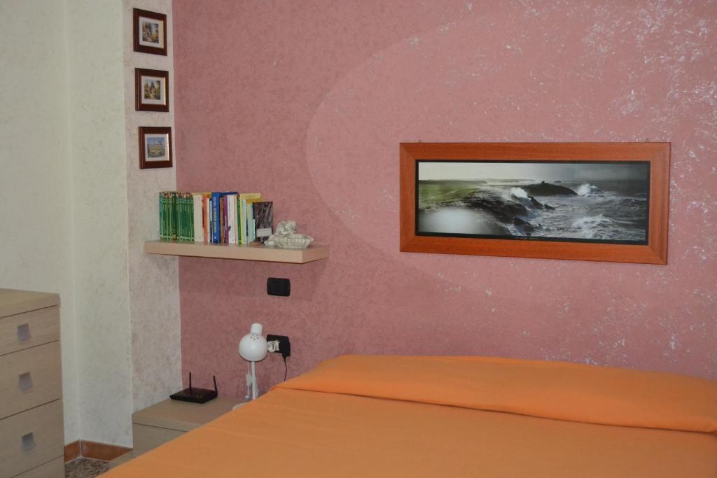sypialnia z łóżkiem z różową ścianą w obiekcie Sweet Home w Cagliari