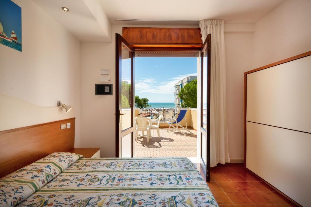 Postel nebo postele na pokoji v ubytování Hotel Coralba