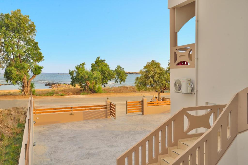 a view of the beach from the stairs of a building at Kolimbito Sea Side in Falasarna