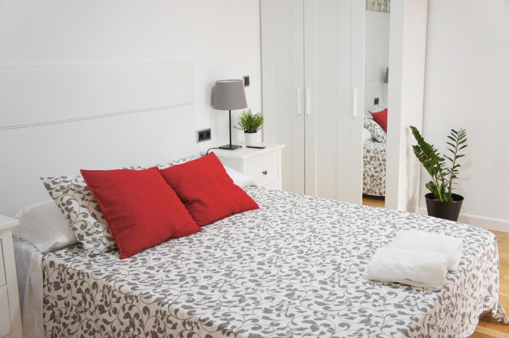 アリカンテにあるSegura 27の白いベッドルーム(赤い枕のベッド付)