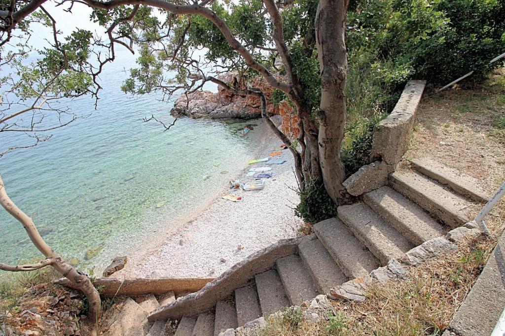 a set of stairs next to a body of water at Apartment Irin Povile in Povile