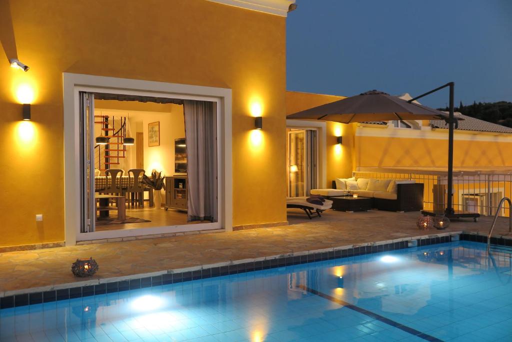 a swimming pool in front of a house at ARILLAS HILLSIDE VILLA 3 - Provence in Arillas