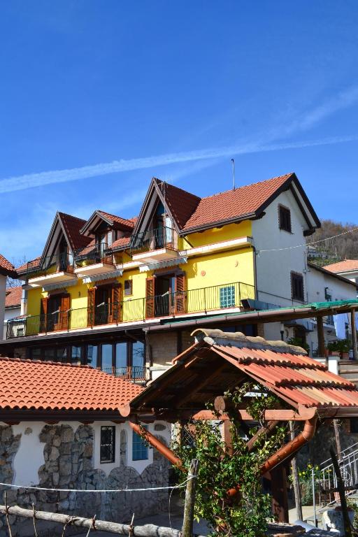 a large yellow building with red roof at Luna D'Agerola in Agerola