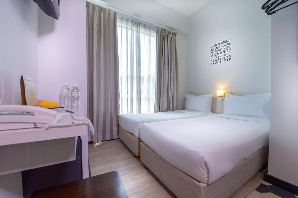 Postel nebo postele na pokoji v ubytování Cititel Express Kota Kinabalu