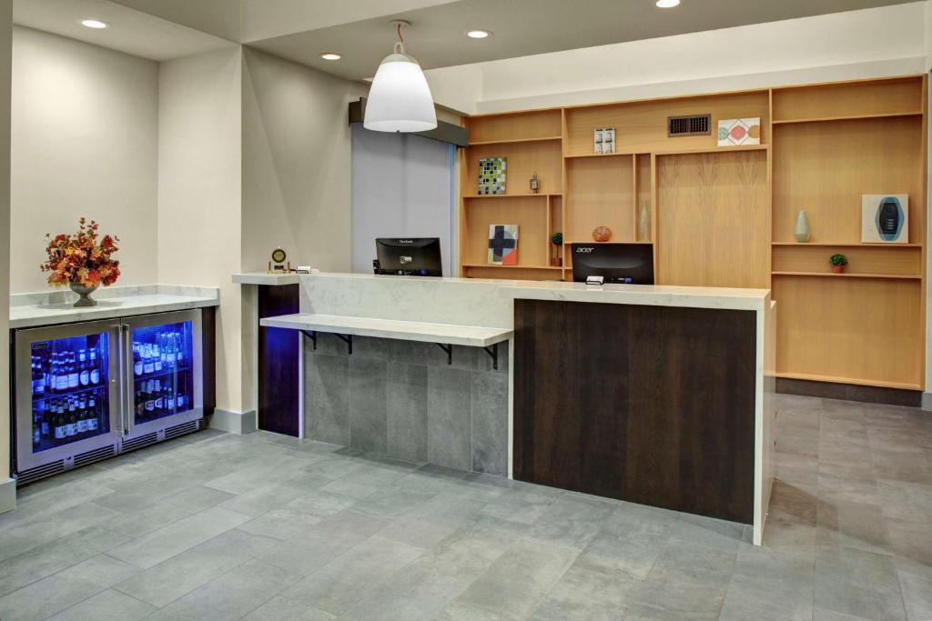 an office lobby with a desk and a fish tank at Hyatt House Dallas Lincoln Park in Dallas