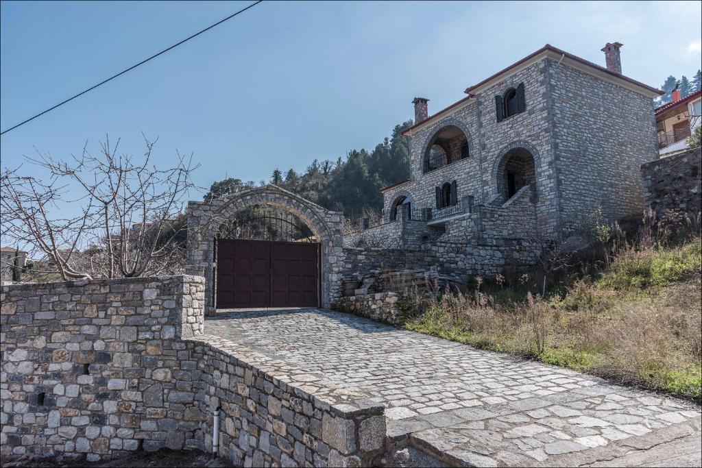 an old stone building with a gate in front of it at Stone Mansion Anavryti, ΑΜΑ 20569 in Mystras