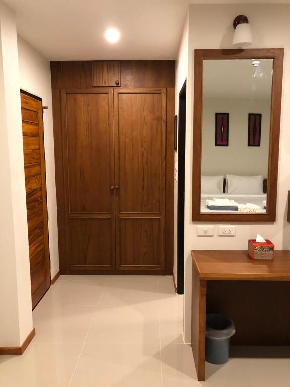 a room with a wooden door and a mirror at Crystal Lamai Hotel in Lamai
