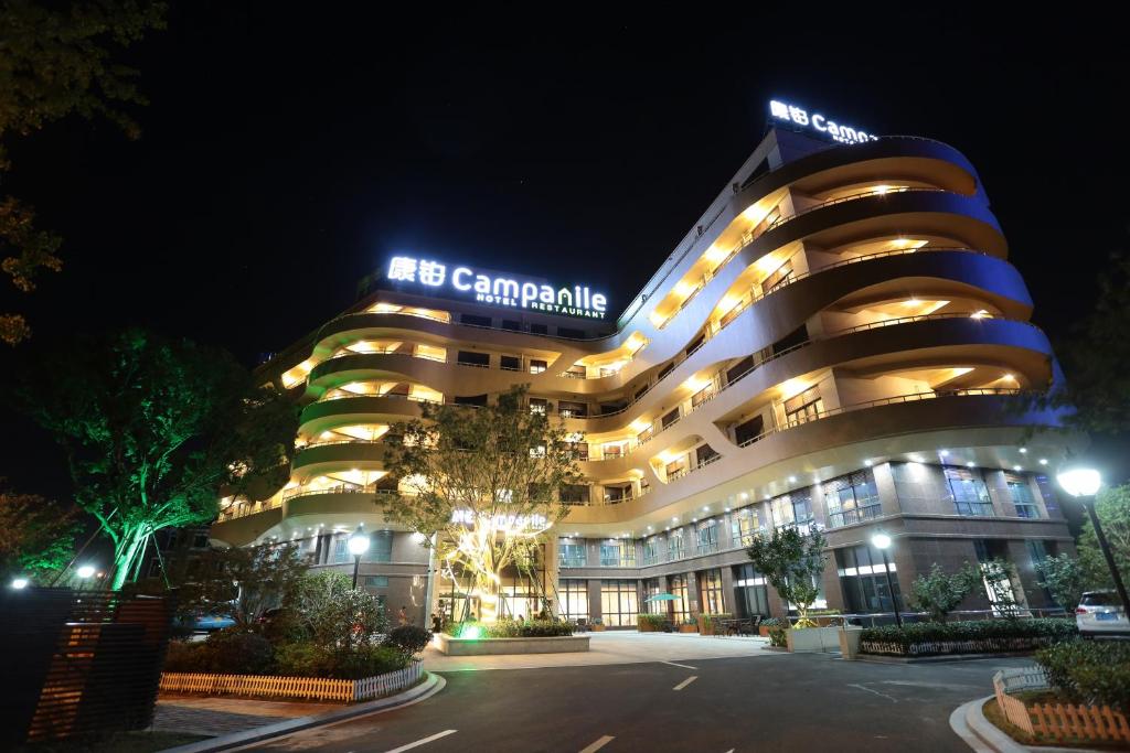 a large building with lights on it at night at Campanile Huzhou Taihu Lake in Huzhou