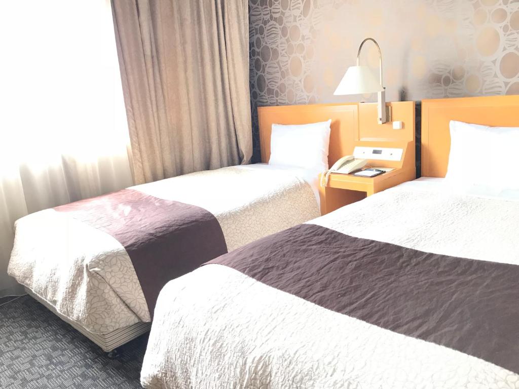 Voodi või voodid majutusasutuse Numazu River Side Hotel toas