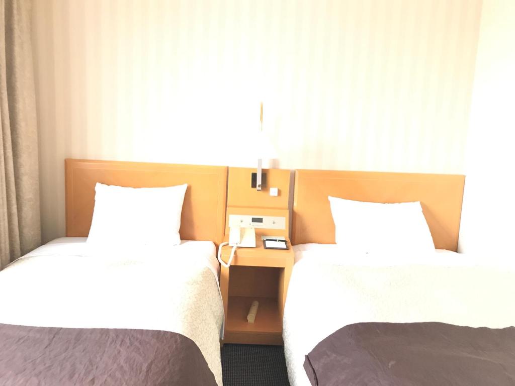 Voodi või voodid majutusasutuse Numazu River Side Hotel toas