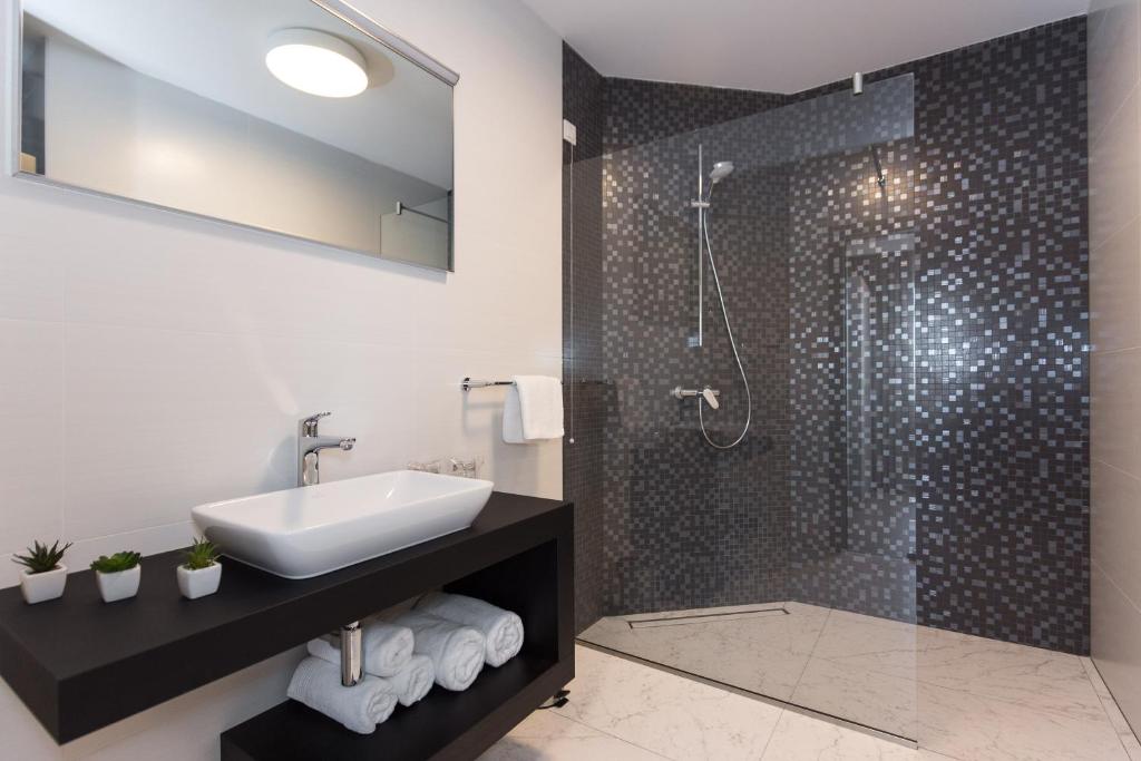 a bathroom with a sink and a shower at Pansion Leggero in Krk