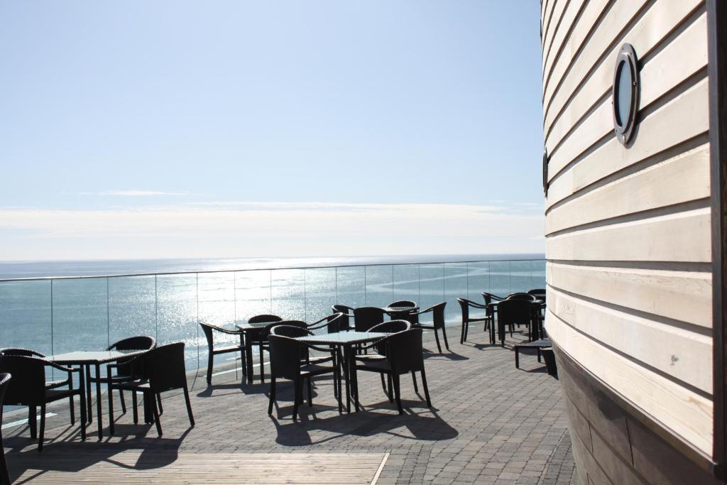 a row of tables and chairs on a balcony at Dunmore House Hotel in Clonakilty