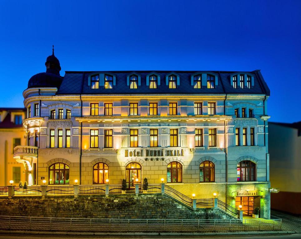 a large building with lights on it at night at Boutique Hotel Dubná Skala in Žilina