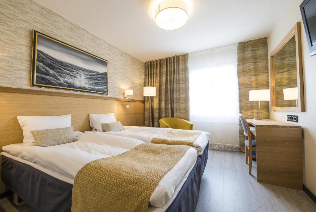 Postel nebo postele na pokoji v ubytování Hotel Aakenus