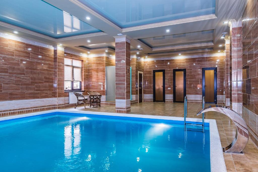 a pool in a room with a brick wall at Residence Park Hotel in Goryachiy Klyuch