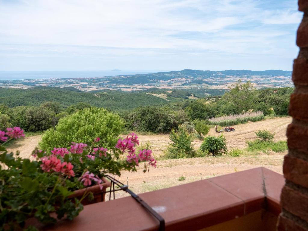 a view from the balcony of a house with flowers at Poderino Bellavista in Castellina Marittima