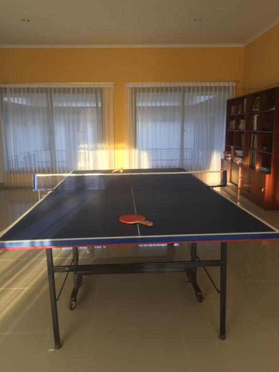 a ping pong table in the middle of a room at Rumah99 in Jakarta