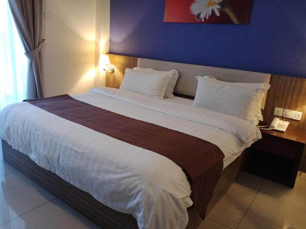 Postel nebo postele na pokoji v ubytování Oscar Suites Hotel