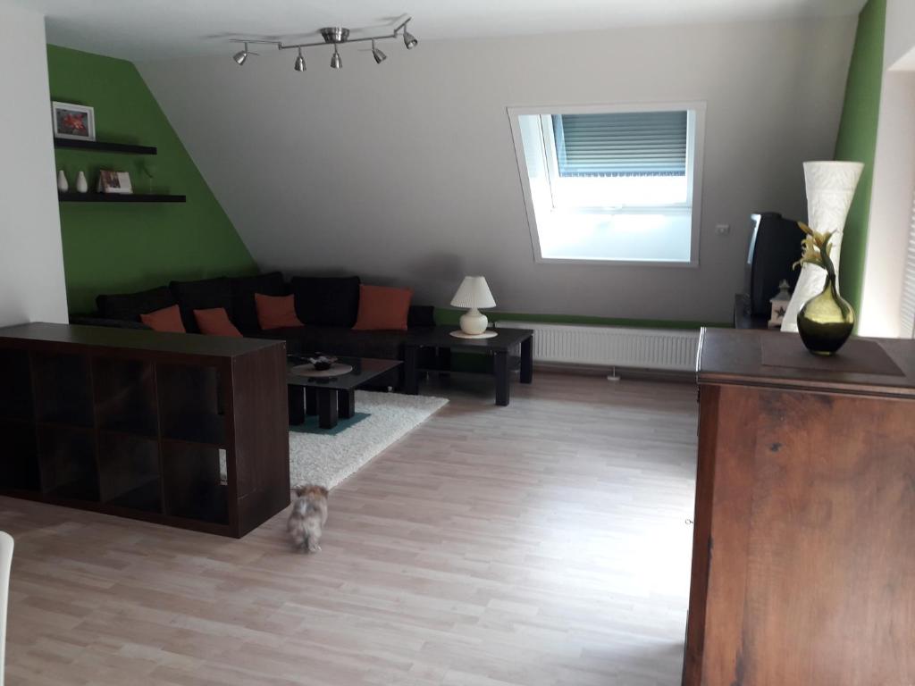 a living room with a dog sitting in the middle at Ferienwohnung im Rhein-Main Gebiet nahe Frankfurt, Rödermark in Rödermark