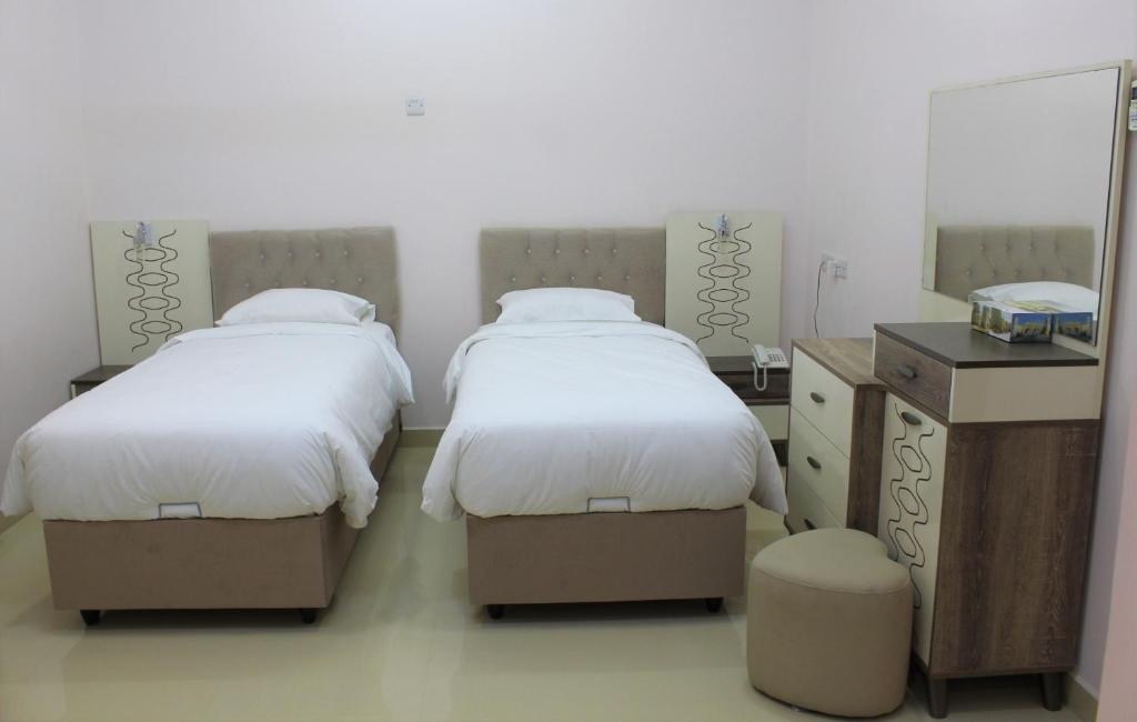 Postel nebo postele na pokoji v ubytování Manarat Manah Hotel Apartments