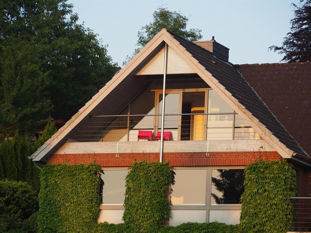 a house with ivy growing up the side of it at Ferienwohnung Haus am Barg in Heikendorf