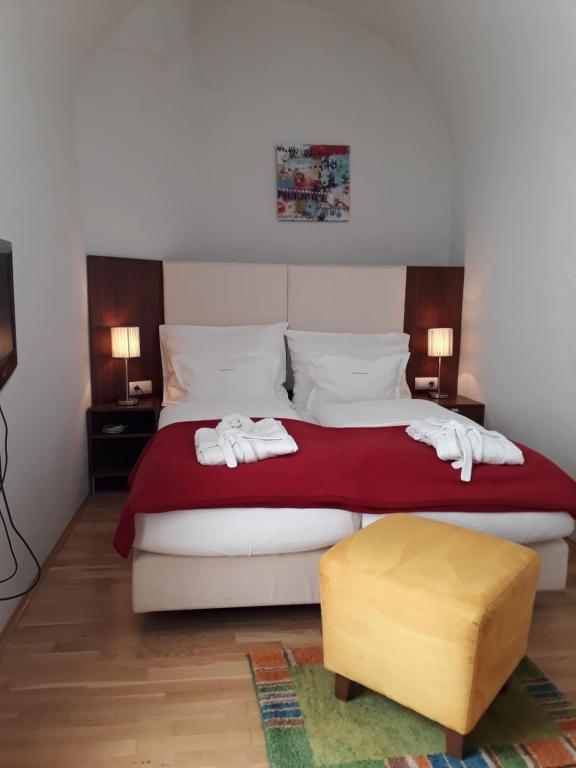 a bed room with a white bedspread and pillows at Ferienappartements Oberstbergmeisteramt in Obervellach