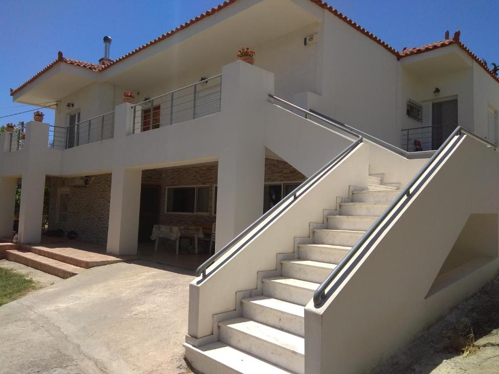 a white house with stairs in front of it at Iliahtida in Chalkida