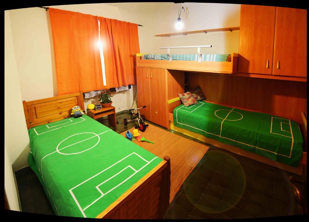 a kitchen with two beds with a soccer field on it at Casa "Il Girasole" in Stintino