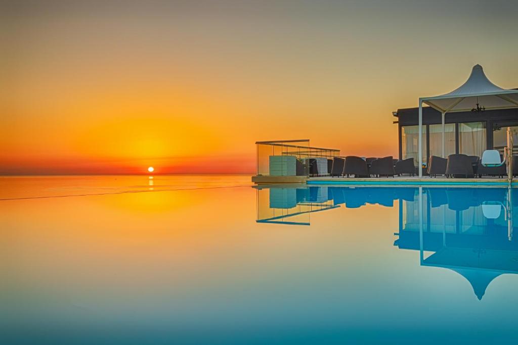 a rendering of a house on the water at sunset at AX The Palace in Sliema