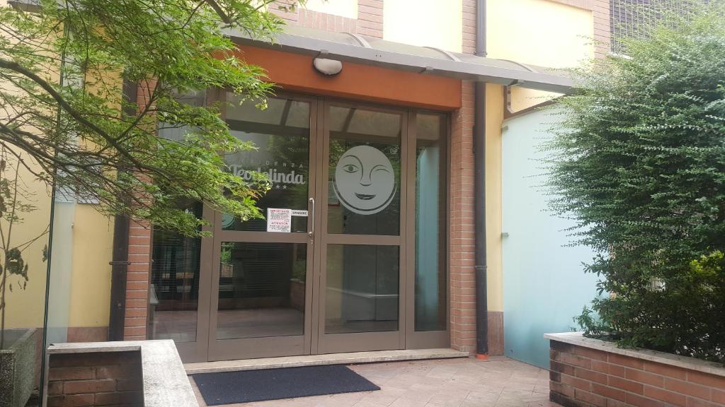 a front door of a building with a smiley face on it at Residenza Teodolinda in Monza
