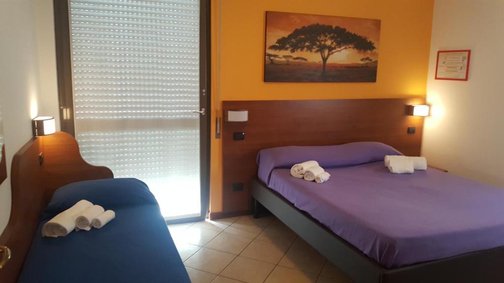 Posteľ alebo postele v izbe v ubytovaní Residenza Teodolinda