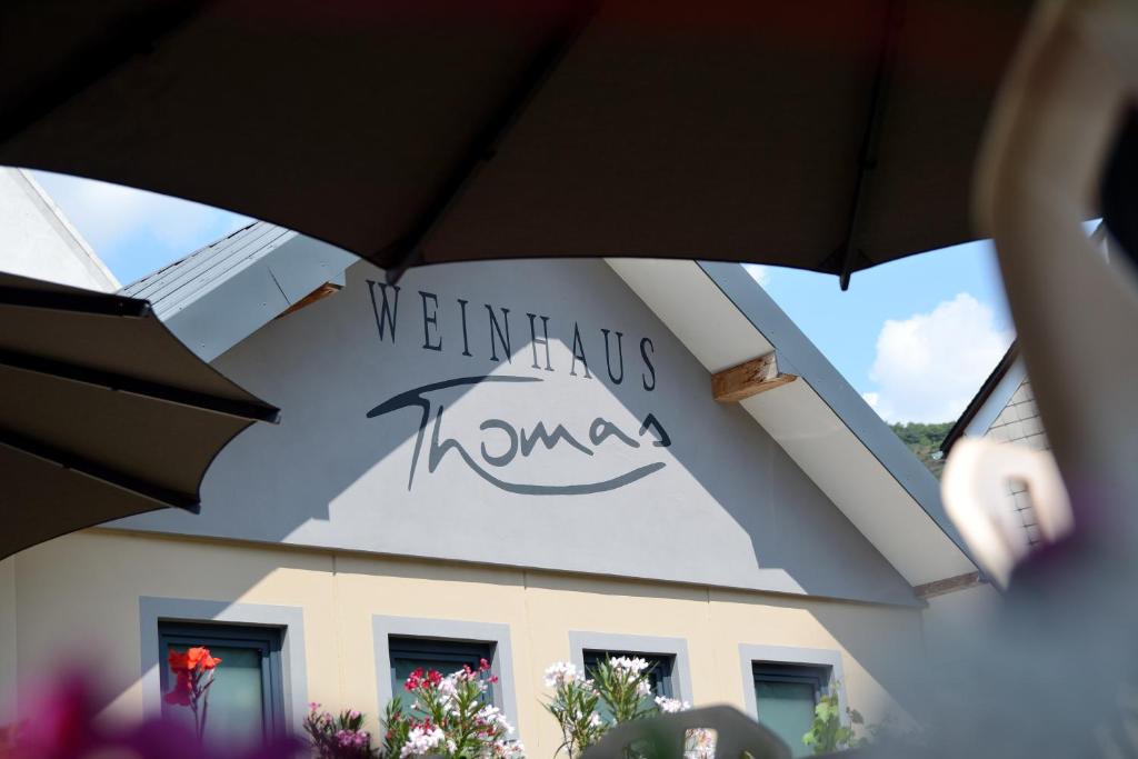 a view of a building from under an umbrella at Weinhaus Thomas in Klotten