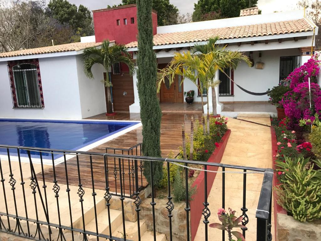 a villa with a swimming pool in front of a house at Casa Al Pie De La Sierra in Oaxaca City