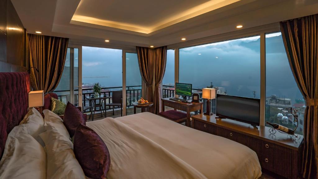a hotel room with a bed and a large window at Sapa Horizon Hotel in Sa Pa
