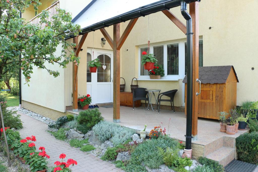 a patio with a wooden pergola in front of a house at Privát Čerenica in Beluša