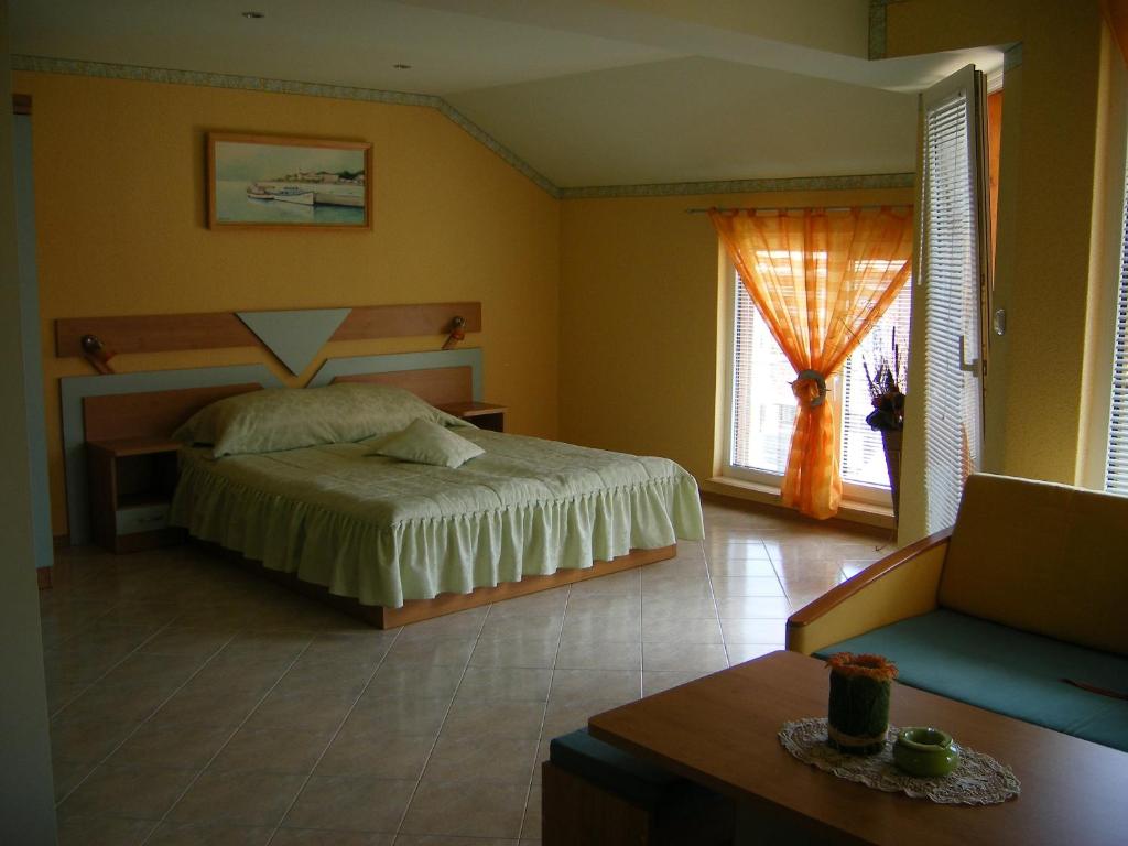 a bedroom with a bed and a large window at Dari Guest Rooms Стаи за гости Дари in Nesebar
