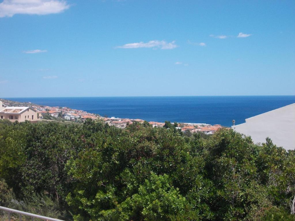 a view of a town and the ocean from a hill at Casa Elena in Cala Gonone