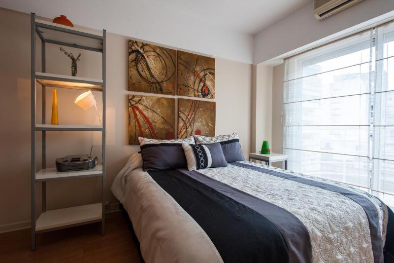 a bedroom with a large bed and a large window at Buenos Aires In Style at Recoleta in Buenos Aires