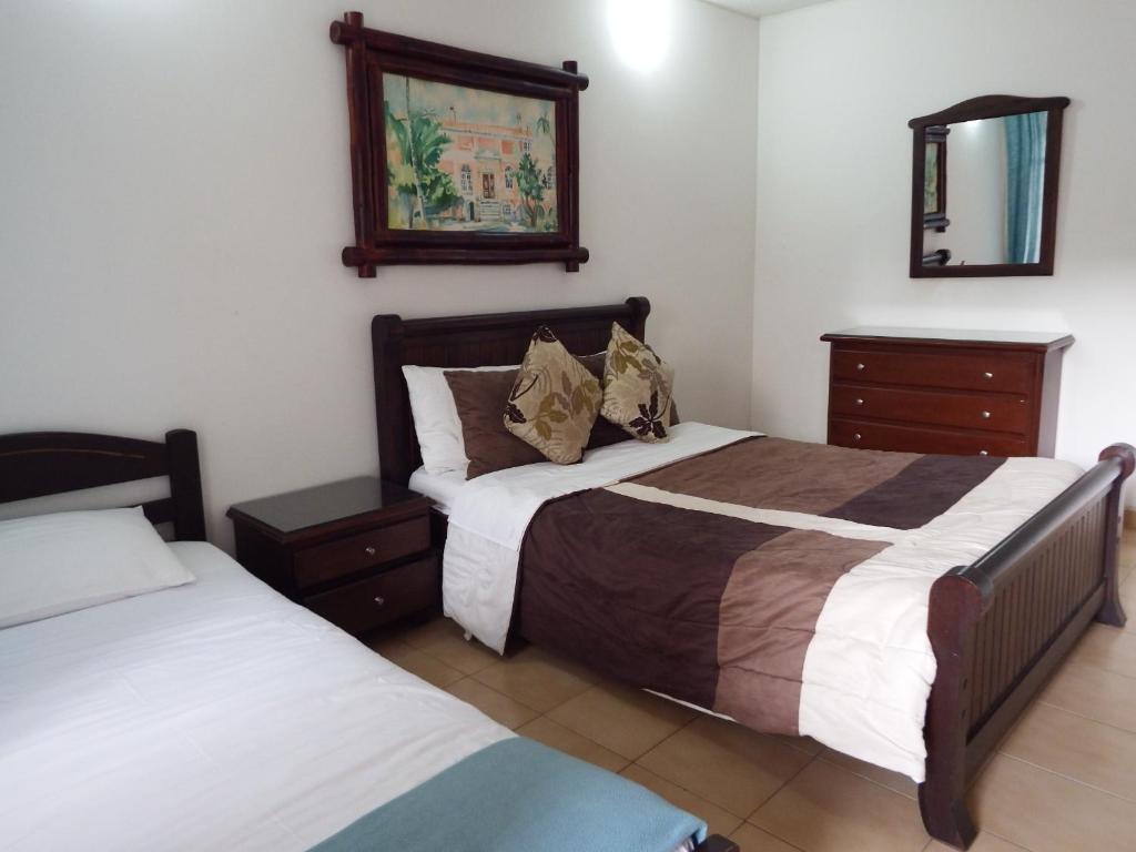 Postel nebo postele na pokoji v ubytování Hotel Campestre Villa Yudy