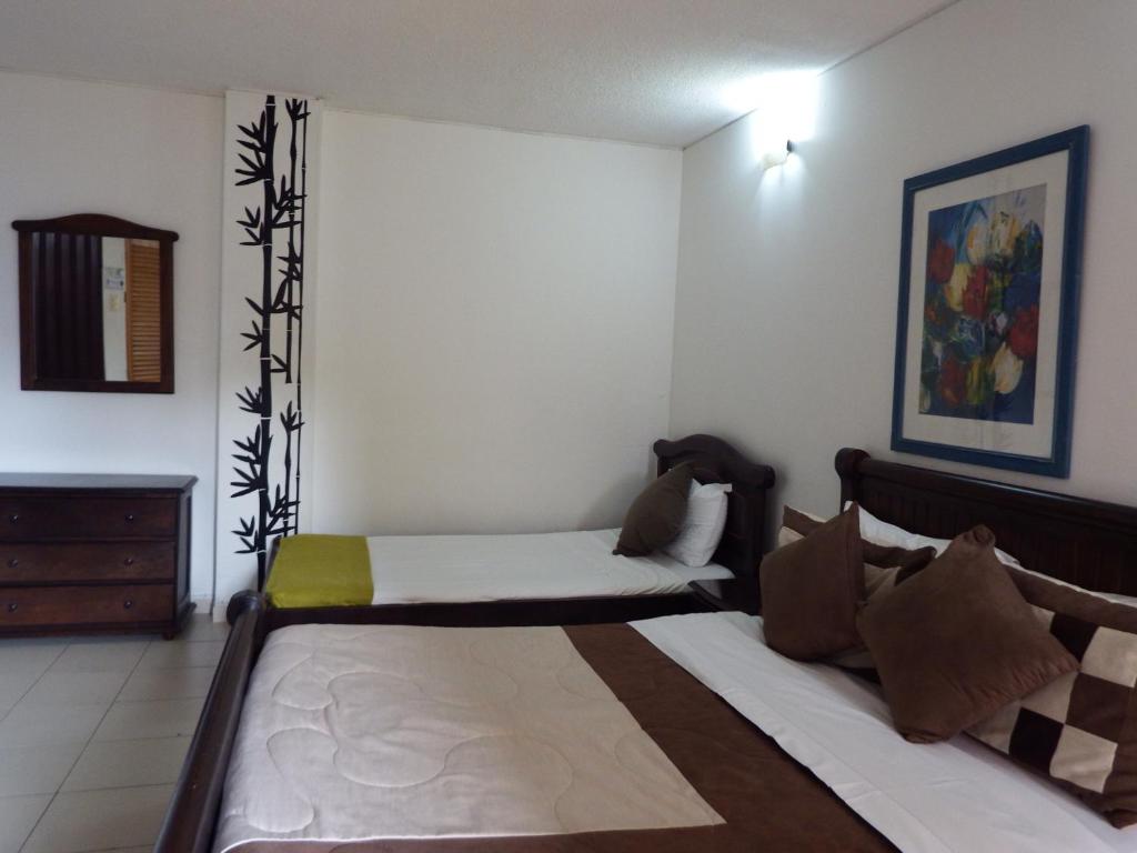 Postel nebo postele na pokoji v ubytování Hotel Campestre Villa Yudy