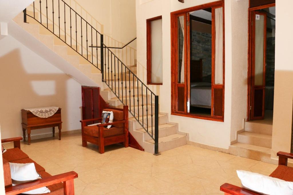 een woonkamer met een trap en een stoel bij Hotel La Gloria Xilitla in Xilitla