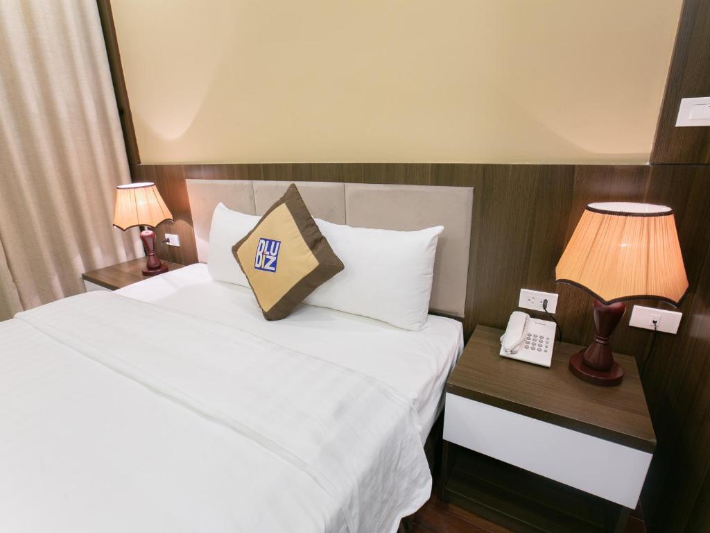 Postel nebo postele na pokoji v ubytování Blubiz Hotel My Dinh Song Da