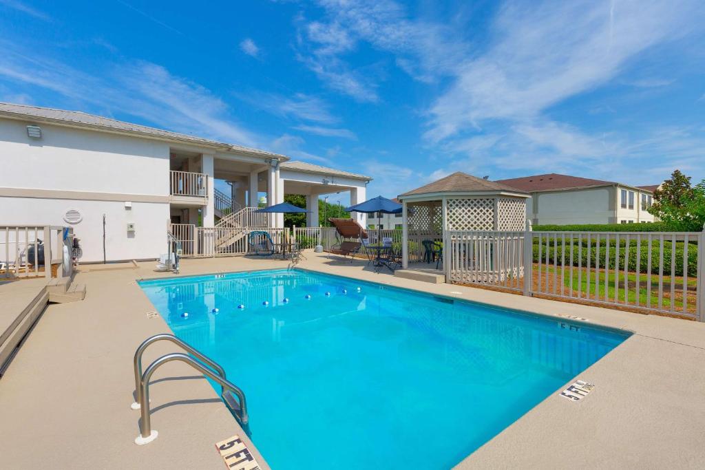 a swimming pool in front of a house at Motel 6-Albany, GA in Albany