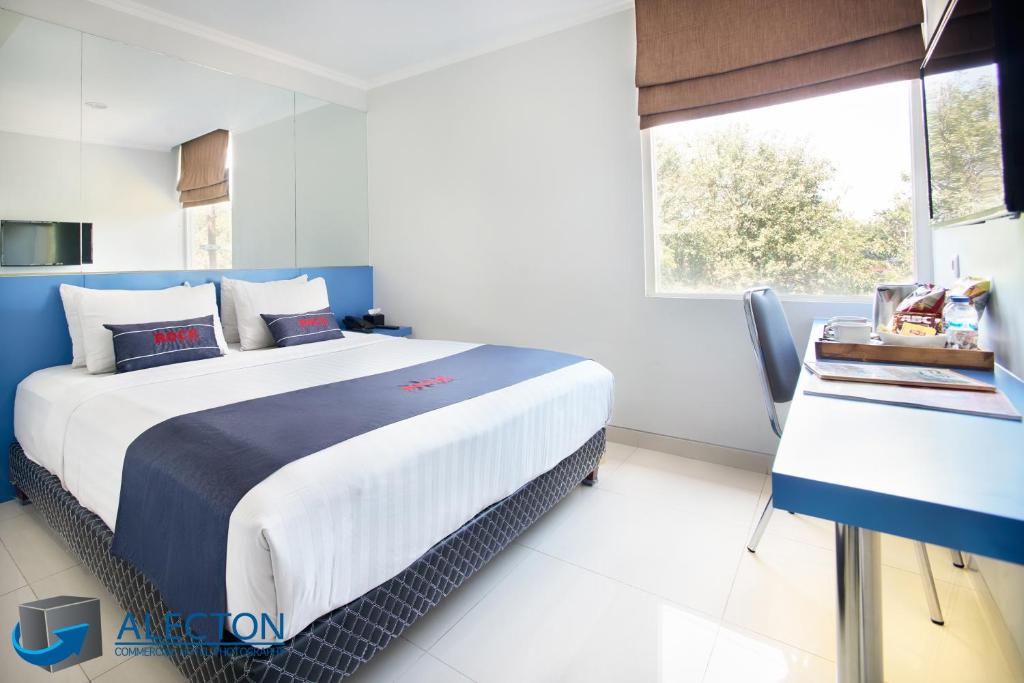 a bedroom with a large bed and a window at Rock Hotel in Krukah