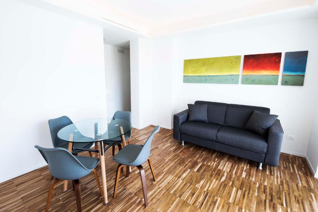 a living room with a table and chairs and a couch at apARTments Sperlonga in Sperlonga